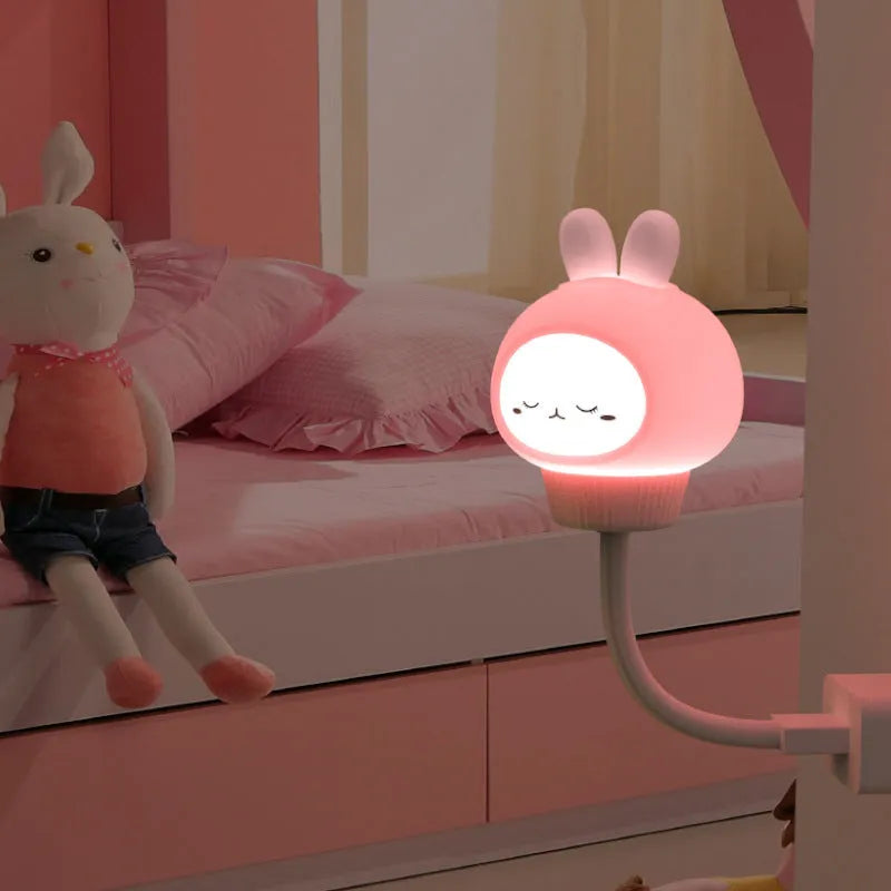 Cartoon bear or rabbit USB LED night light with remote control on a bedside table