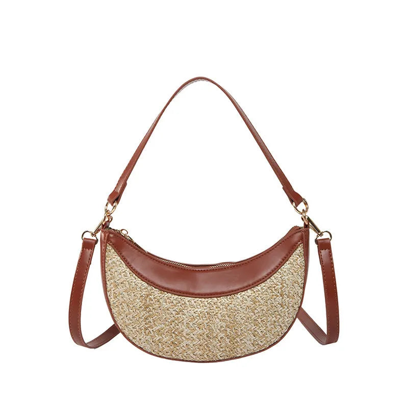Hard structured straw dumpling shaped women's crossbody shoulder bag in black with contrast stitching.