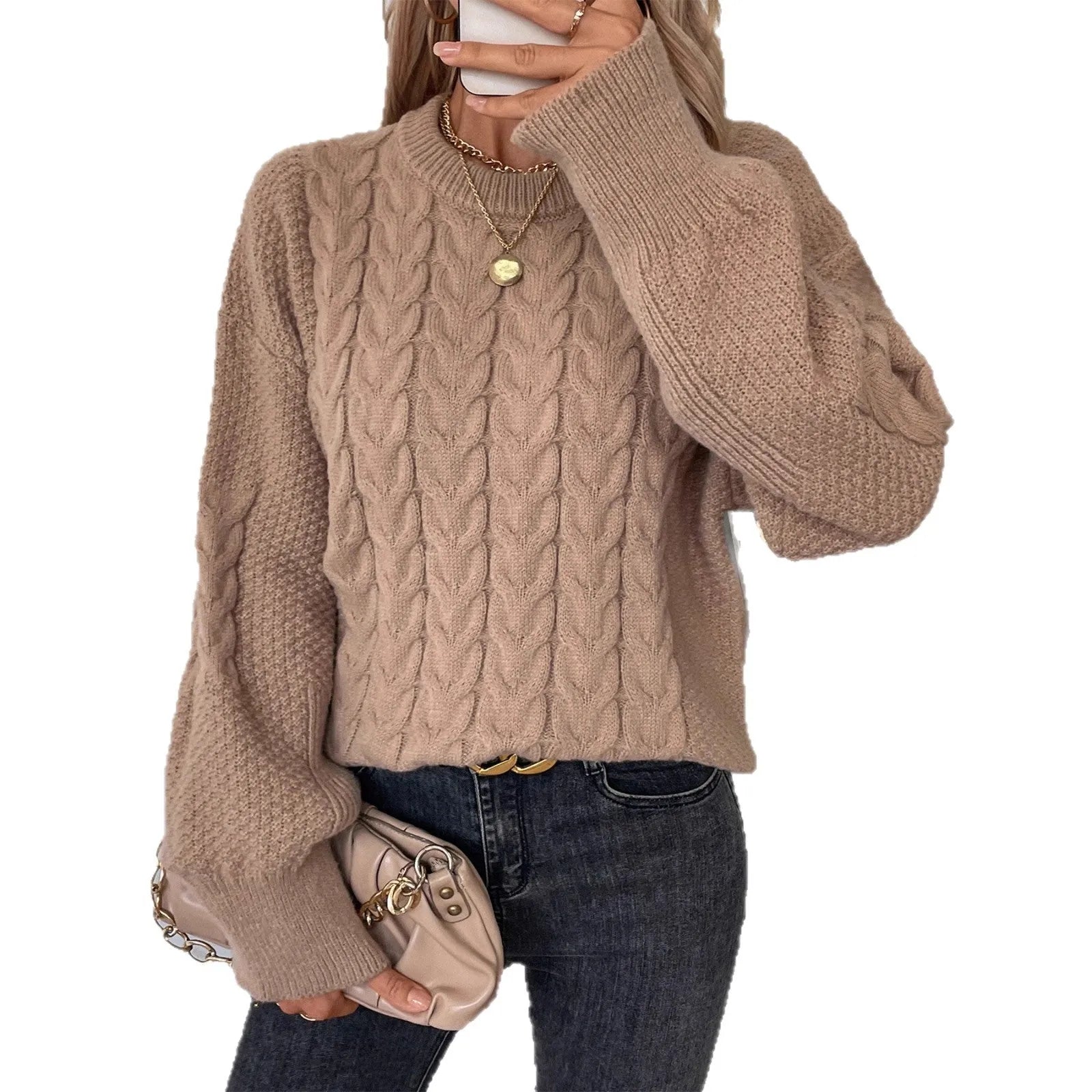 Woman wearing a loose beige casual sweater with a twisted texture detail on the front.