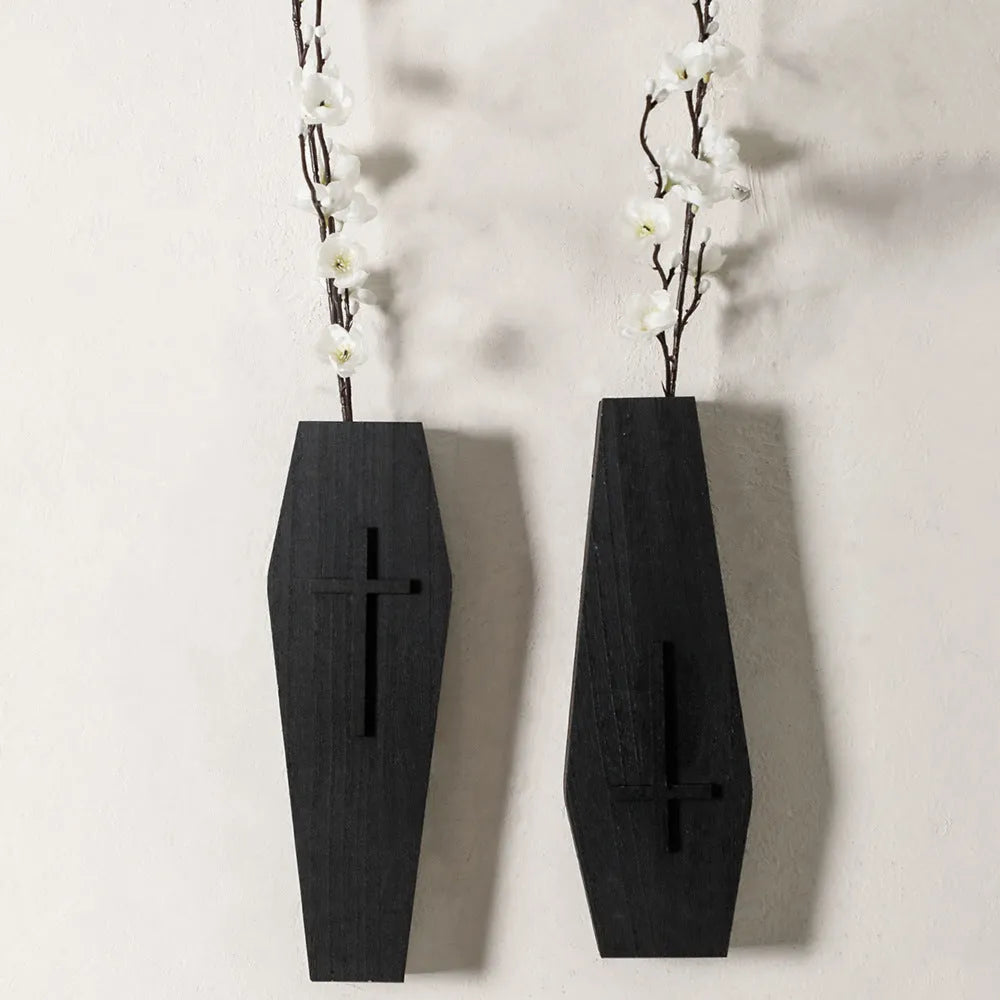 Black cross-shaped wooden wall shelf for home decoration, measuring 27 by 9 centimetres.