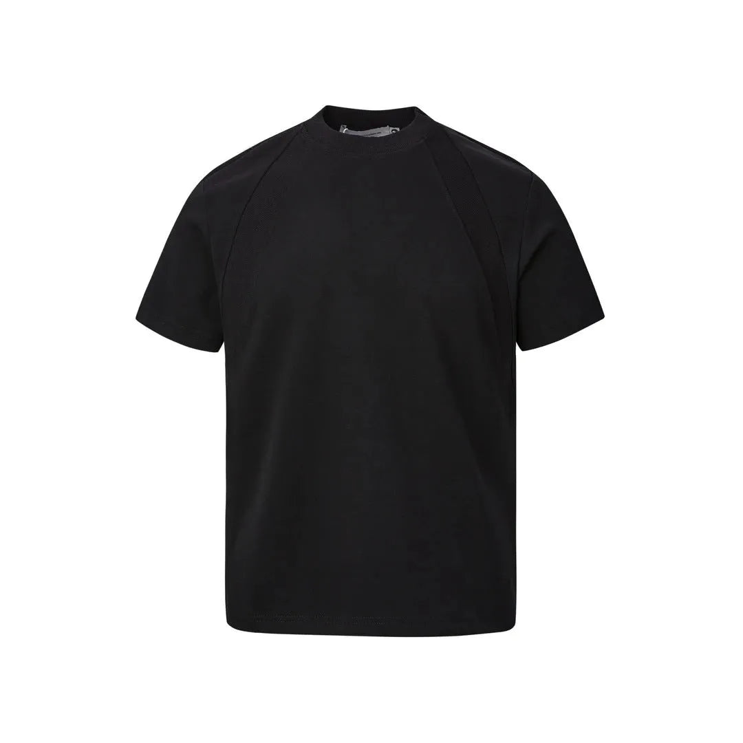 Man wearing a loose-fit grey short sleeve polyester top with air layer stitching.