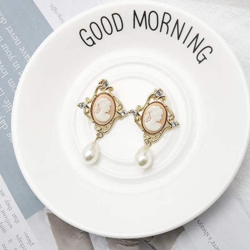 Gold alloy retro embossed geometric earrings on a surface