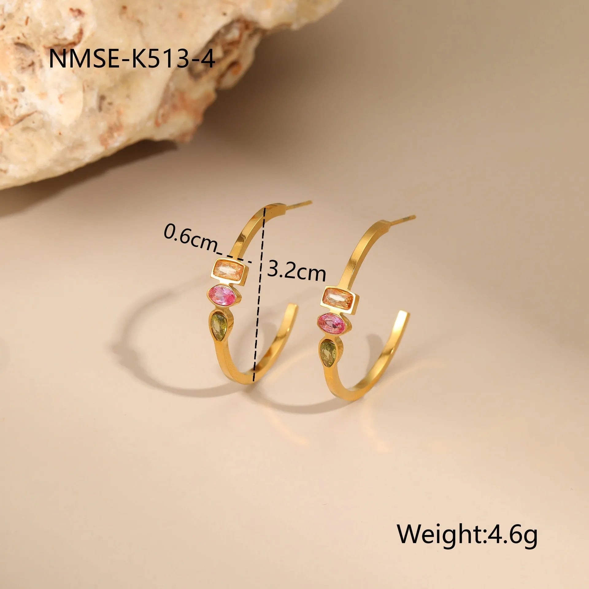 Geometric gold plated zircon jewellery set showing necklace, ring, and earrings on a grey background.