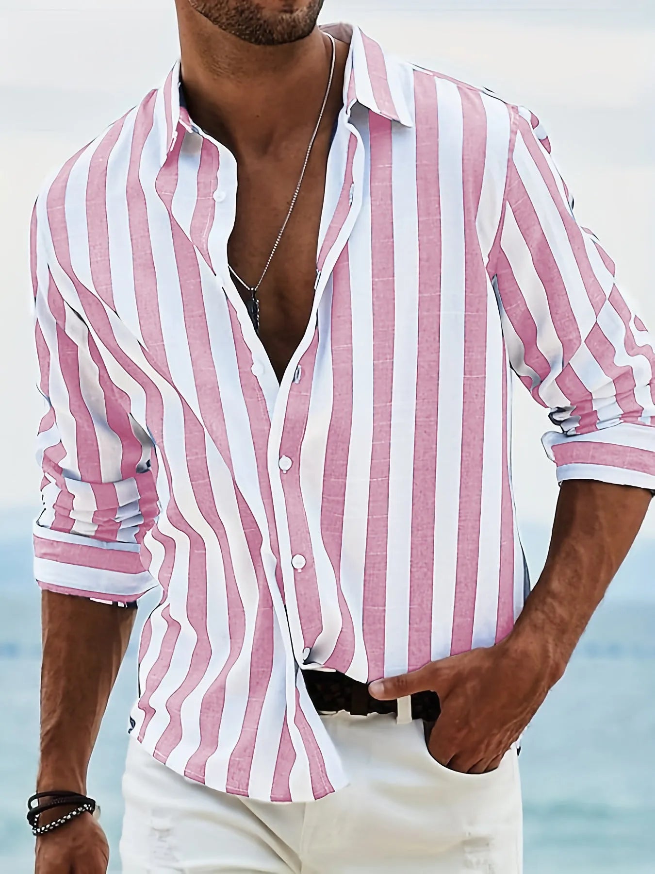 Man wearing a grey and white striped loose-fit long-sleeved casual shirt