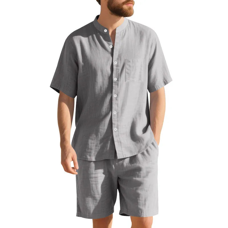 Man wearing a light blue short-sleeve linen blend suit jacket and matching shorts with a Henry collar.