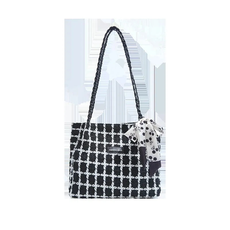 Black woven wool shoulder bag showing internal organisation with phone pocket, document section and zipper compartment