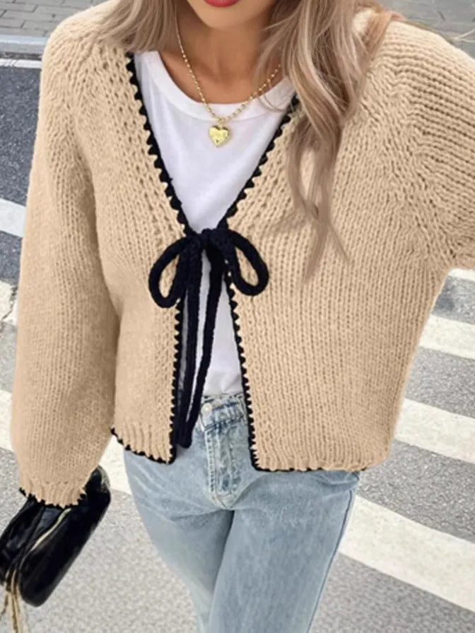 Gray lace-up cardigan sweater with long sleeves and crocheted flower decoration on the front.