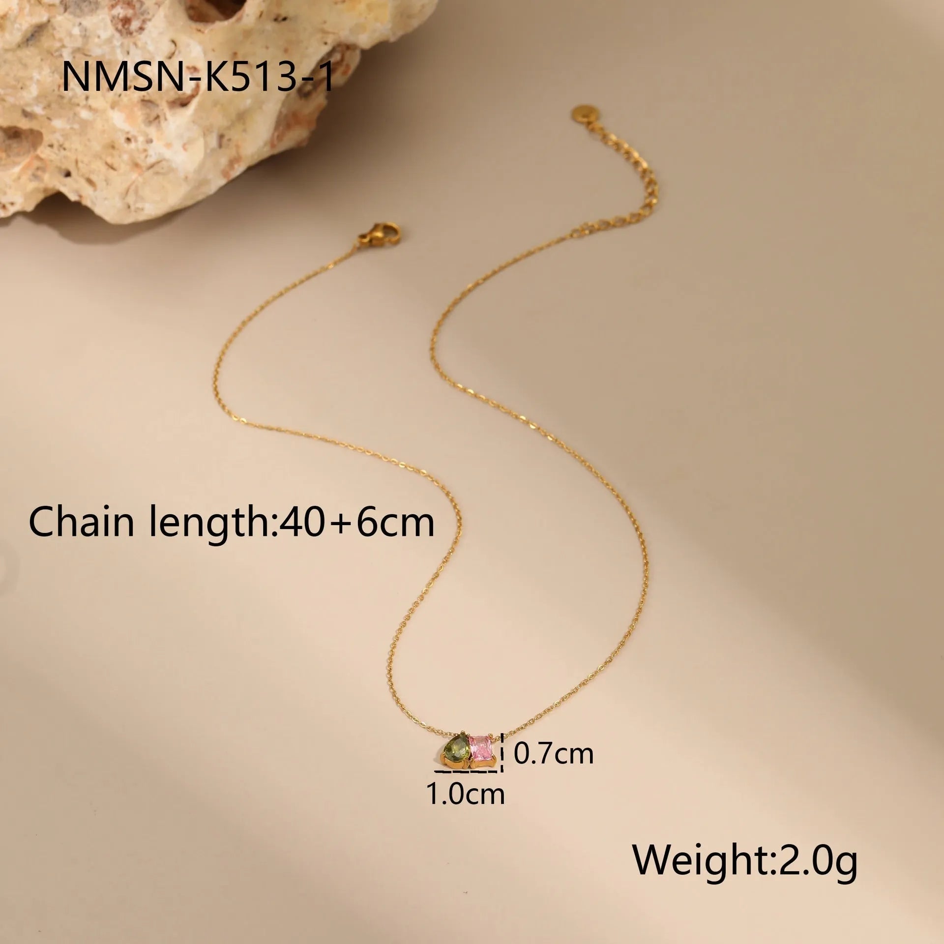 Geometric gold plated zircon jewellery set showing necklace, ring, and earrings on a grey background.
