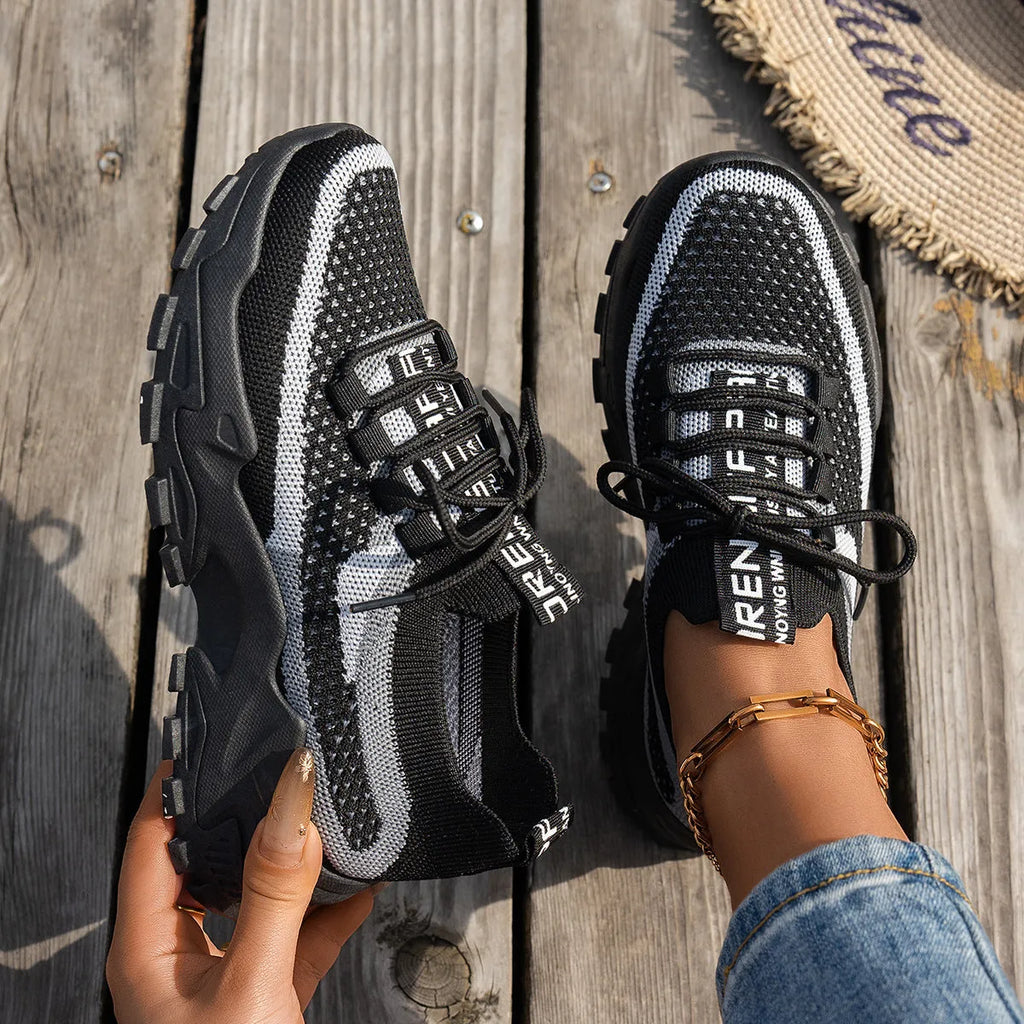 Women's Flyknit Mesh sneakers in a neutral colour showing lace-up design and rubber sole.