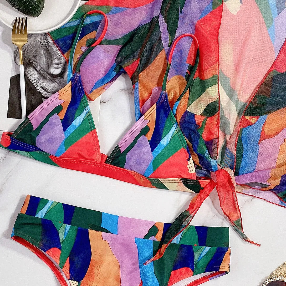 Red women's printed split swimsuit with triangle bikini briefs for swimming and surfing.