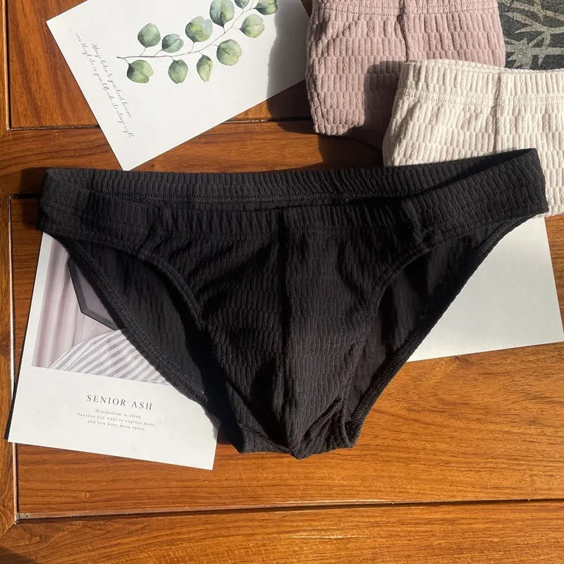 Men's solid colour cotton triangle briefs in mid-waist style, shown in apricot and black colour options.