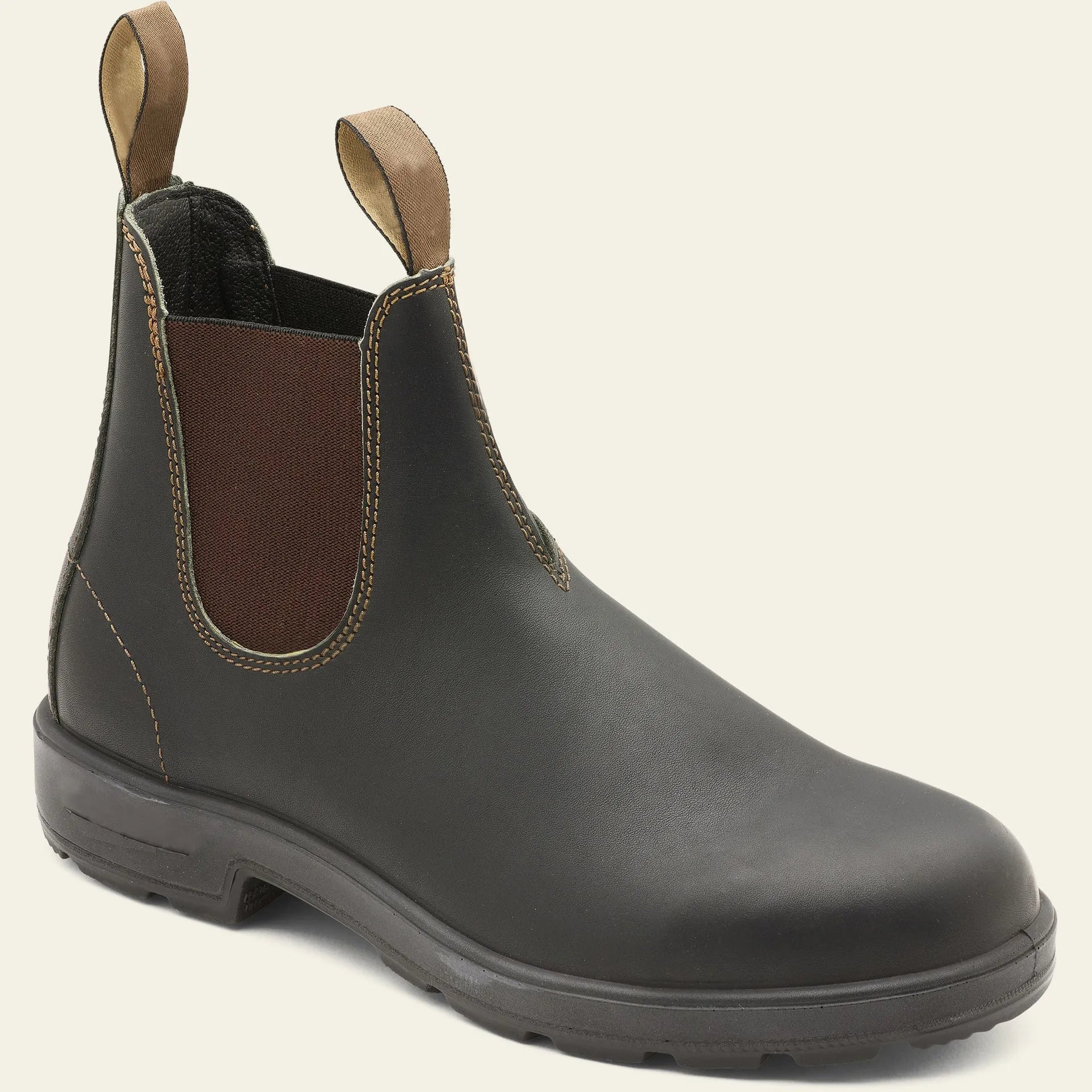 Vintage brown unisex Chelsea boots with a frosted finish, round toe, and low horseshoe heel on a wooden floor.