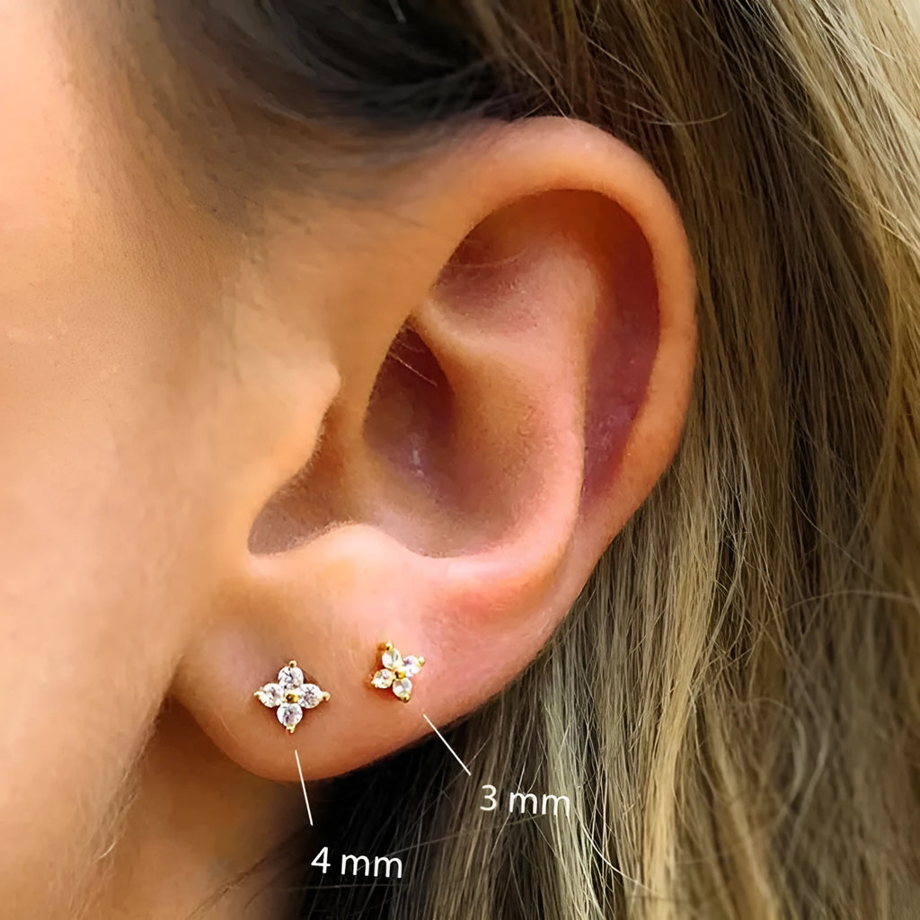 S925 sterling silver stud earrings with a petal-shaped crystal flower in gold or platinum finish.