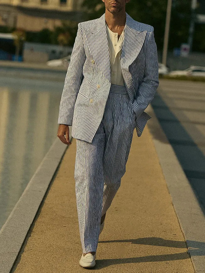 Blue and white striped polyester two-piece suit set with blazer and trousers on a hanger.