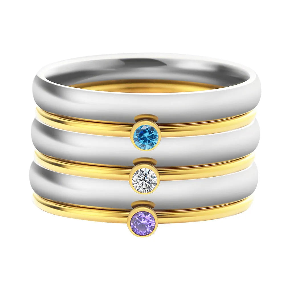 A geometric titanium steel ring featuring an engraved December birthstone design on a grey background.