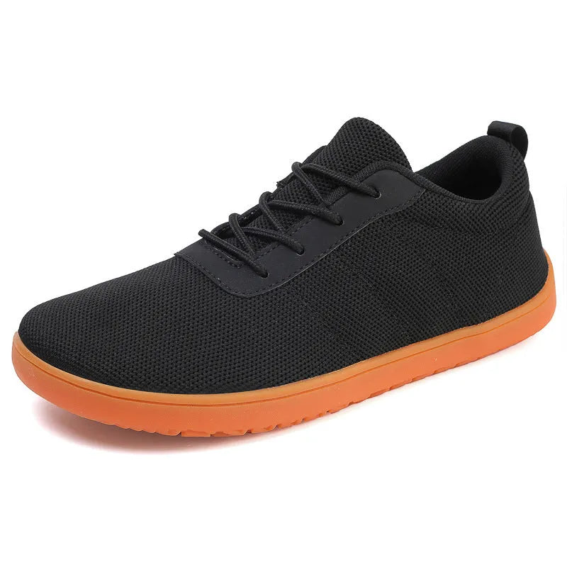 Men's black Flyknit walking shoes with wide round toe and flat rubber sole on a white background.