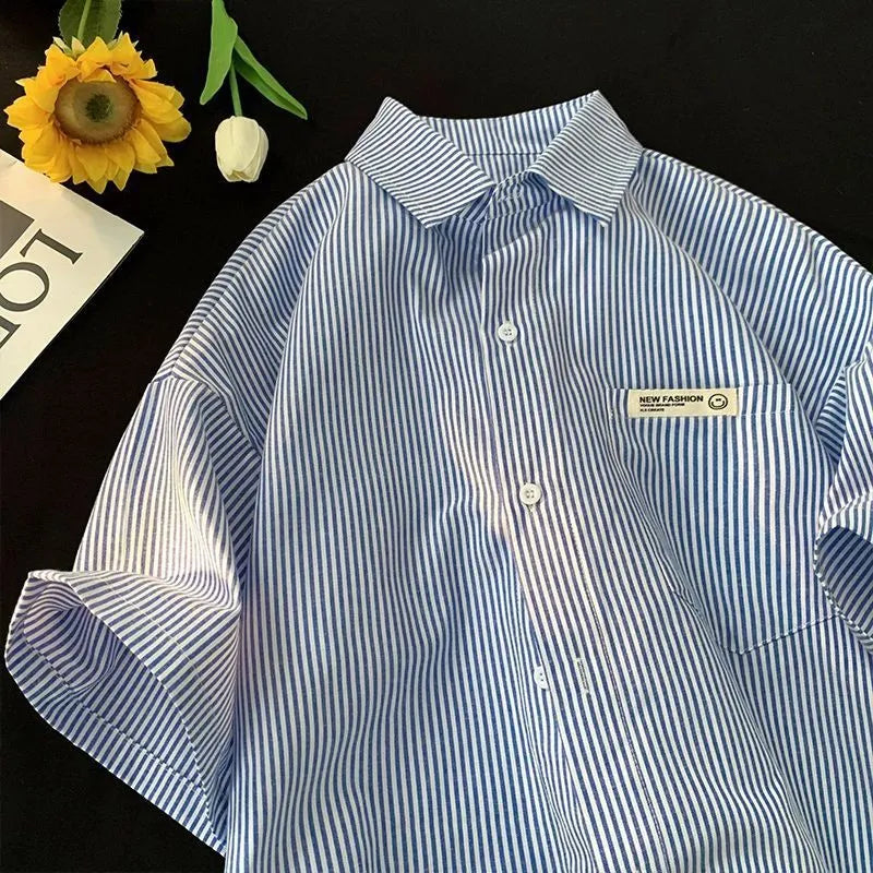 Blue and green striped loose plus size half sleeve polyester shirt on hanger