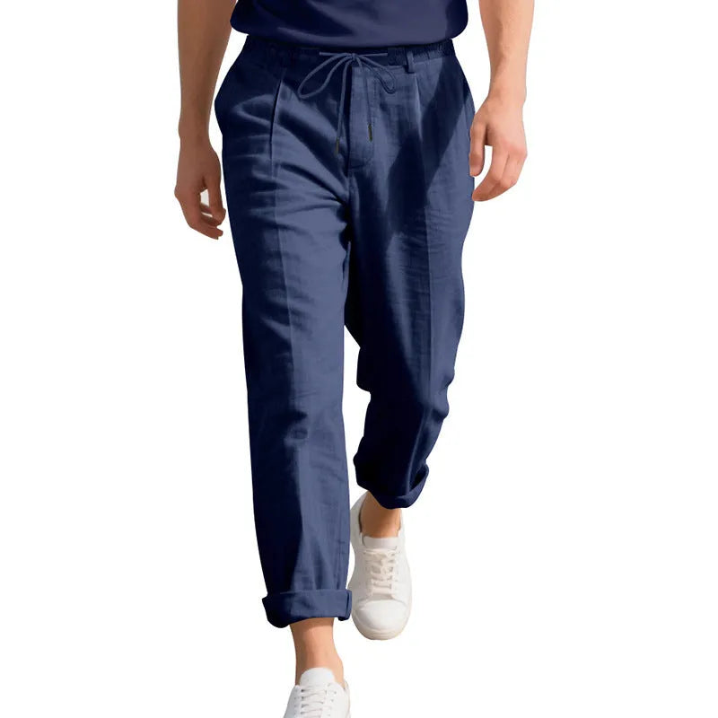 Men's light khaki linen casual trousers with a drawstring waist and straight-leg fit on a hanger.