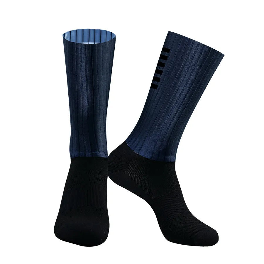 Pair of breathable chemical fibre blend athletic socks for cycling and running, shown in orange colour.