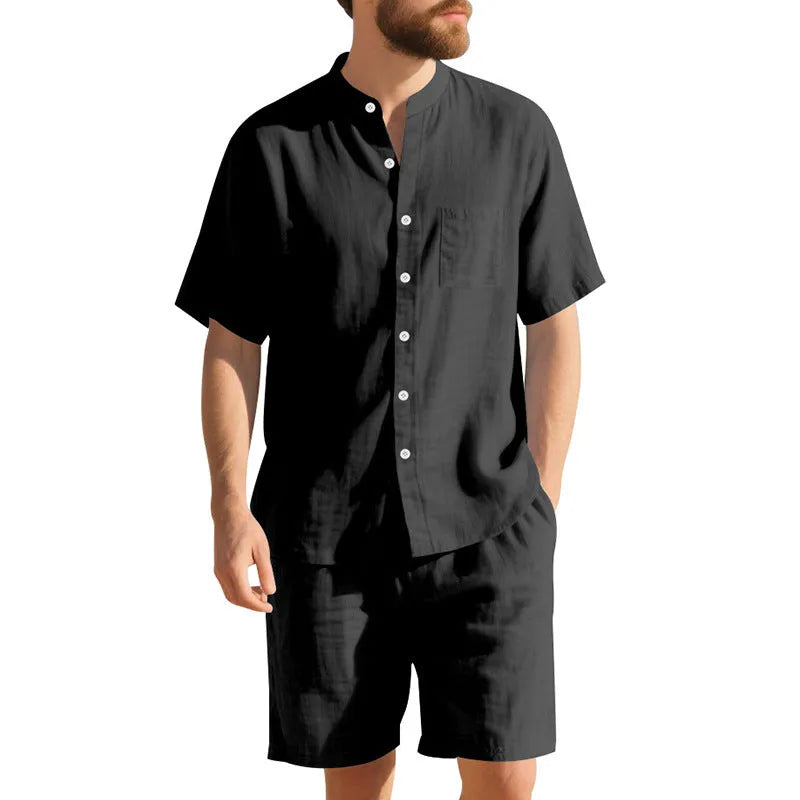 Man wearing a light blue short-sleeve linen blend suit jacket and matching shorts with a Henry collar.