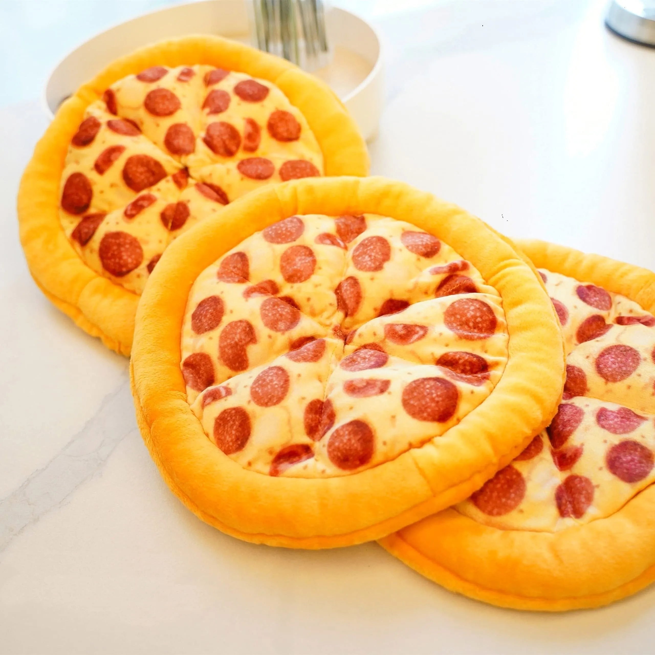 Yellow pizza slice shaped soft fabric dog chew toy with internal squeaker.