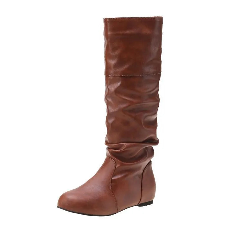 Women's black flat slip-on boots with round toe and high ankle shaft.