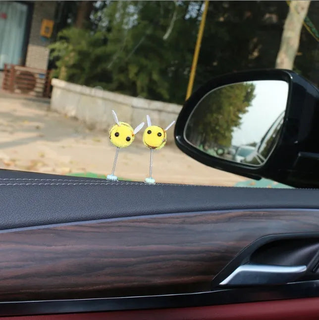 Swing spring bee car decoration made from soft fur ball, showing cartoon bee shape.