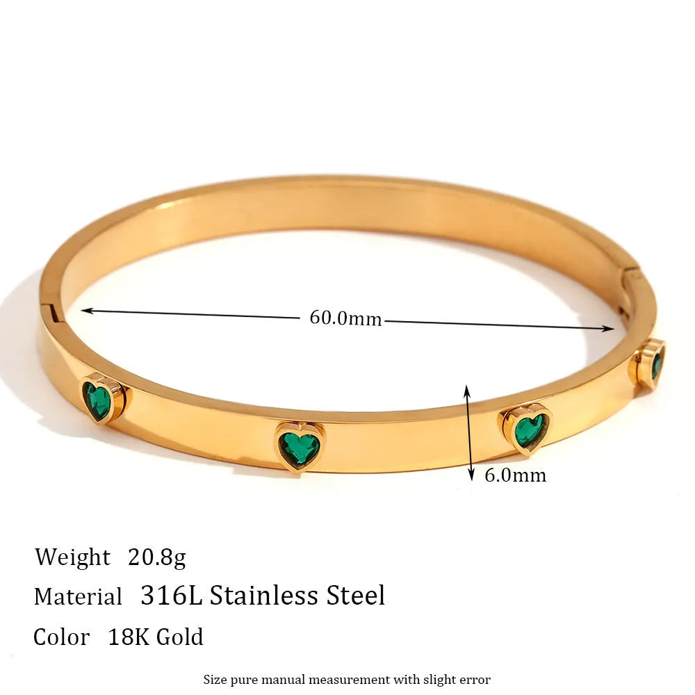 Golden stainless steel bracelet with a small micro-inlaid peach heart pendant.