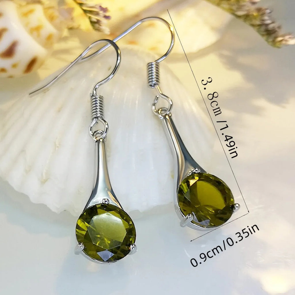 Olive green topaz coloured alloy drop earrings in a water drop shape on a white background.