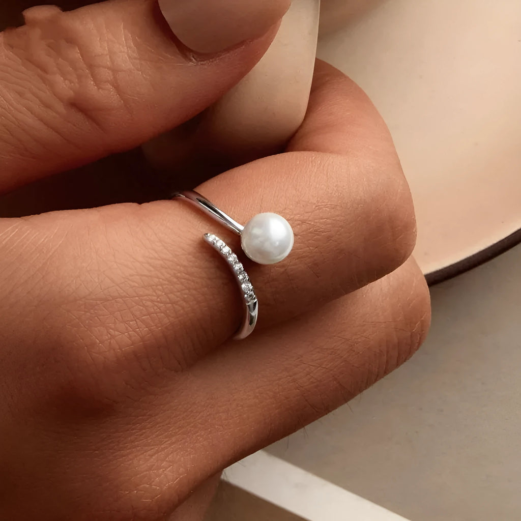 Adjustable sterling silver ring with natural shell pearls showing open loop design