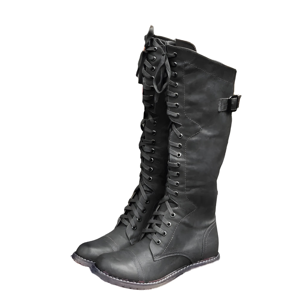 Women's black artificial PU knight boots with cross straps and buckle fastenings.
