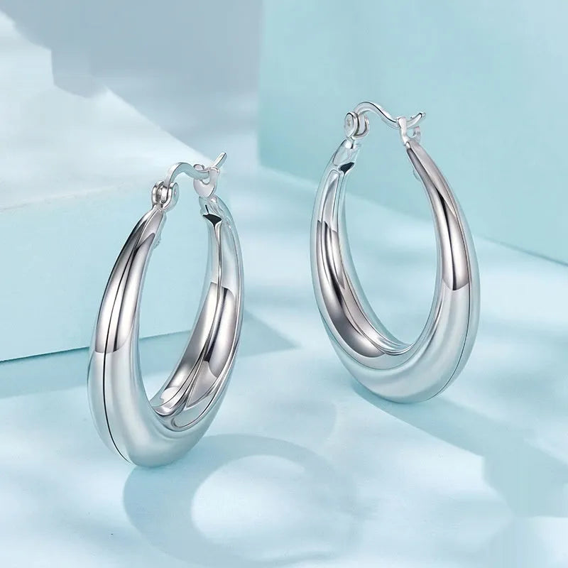 Women's geometric ring clip earrings in silver finish, available in three sizes