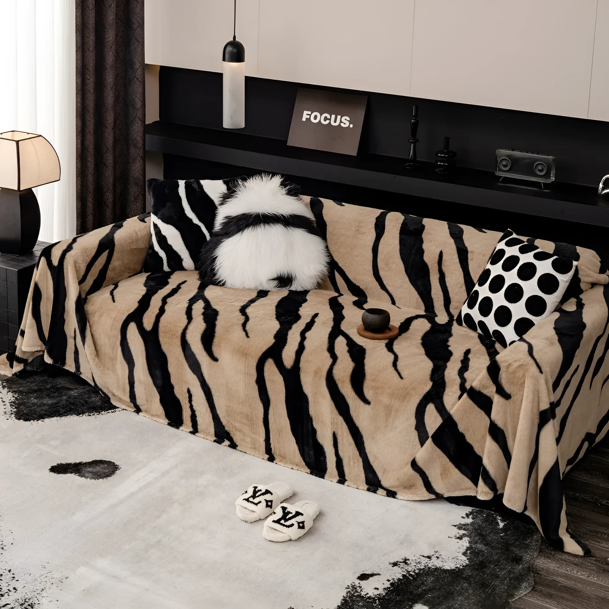 Zebra pattern flannel sofa slipcover in caramel colour, shown draped over a sofa with matching square pillow.
