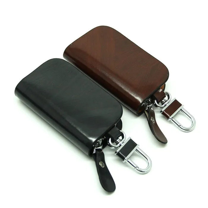 Genuine leather car key case with zipper in black and brown frosted finish.