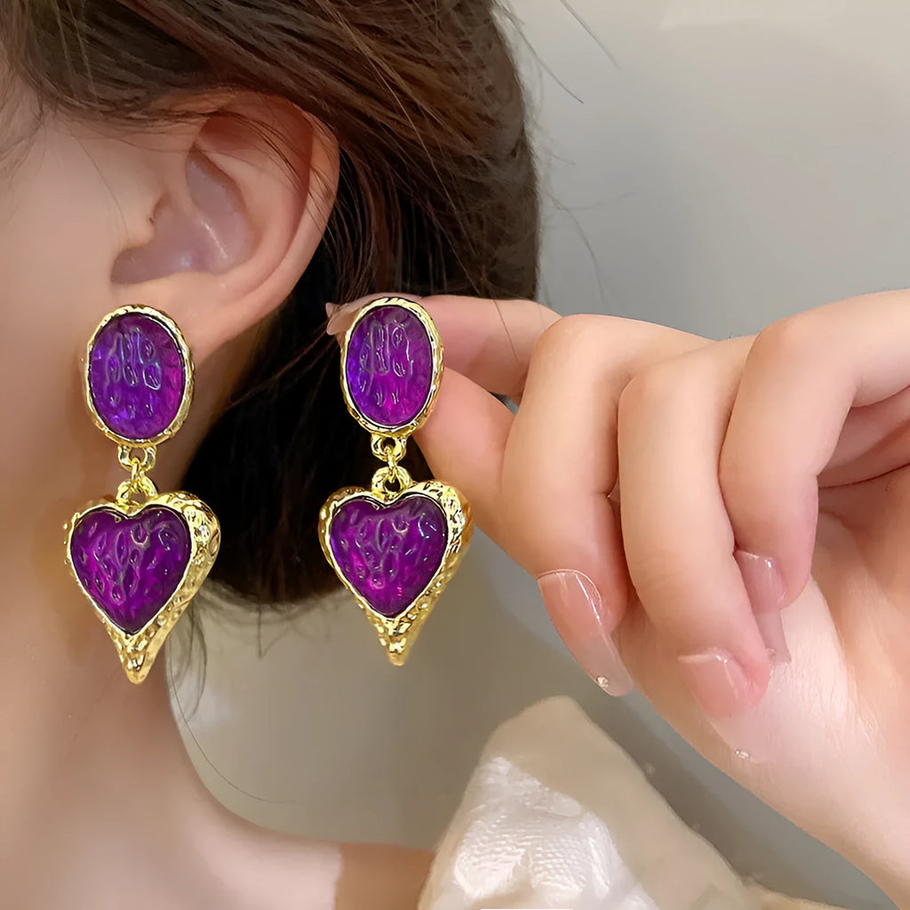 Pleated oval heart stud earrings in alloy showing four colour options