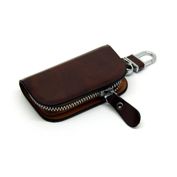 Genuine leather car key case with zipper in black and brown frosted finish.