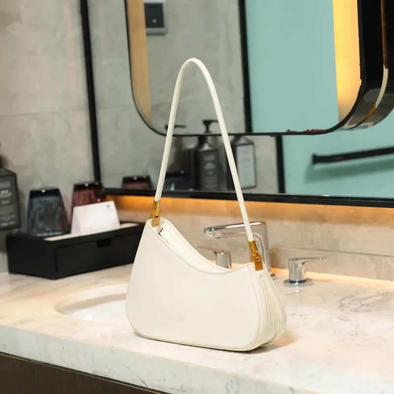 Women's oval retro underarm handbag in PU leather, shown in one of seven colours with a single strap and sewing line detail.