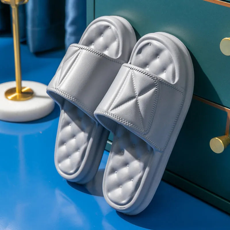 Pair of thick-soled EVA bathroom slippers in various colours, showing non-slip sole texture.