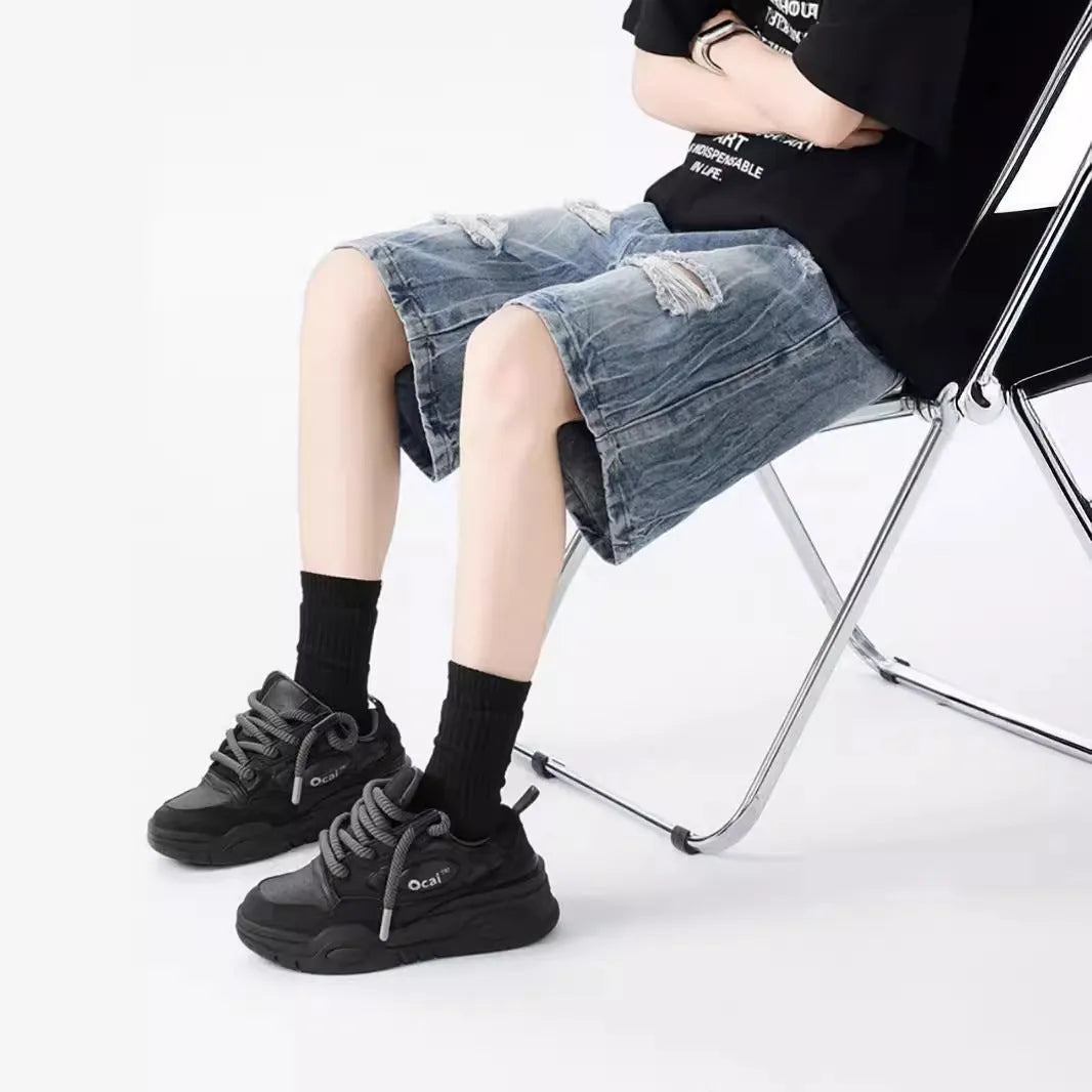 Men's vintage denim shorts with distressed detailing in loose fit design