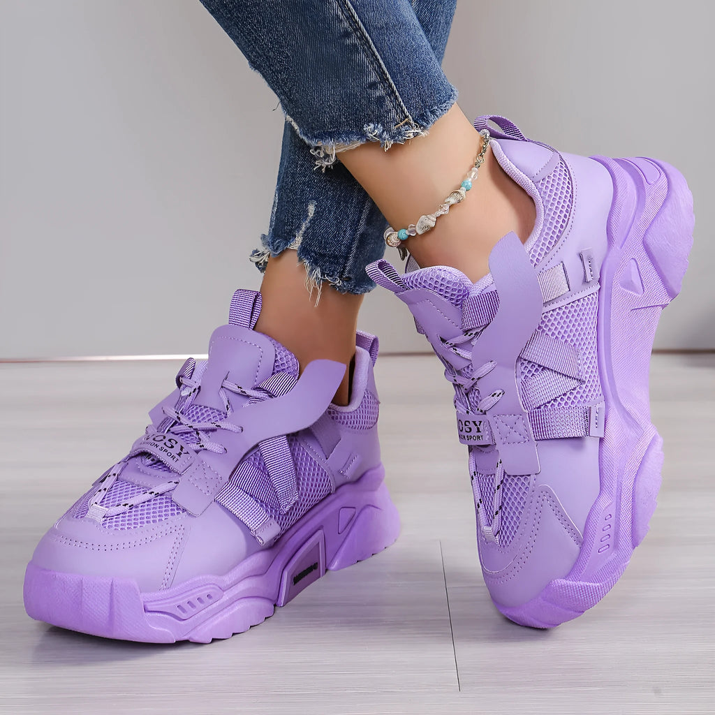 Women's platform sneakers in purple with mesh upper, animal pattern detail, and lace-up front.