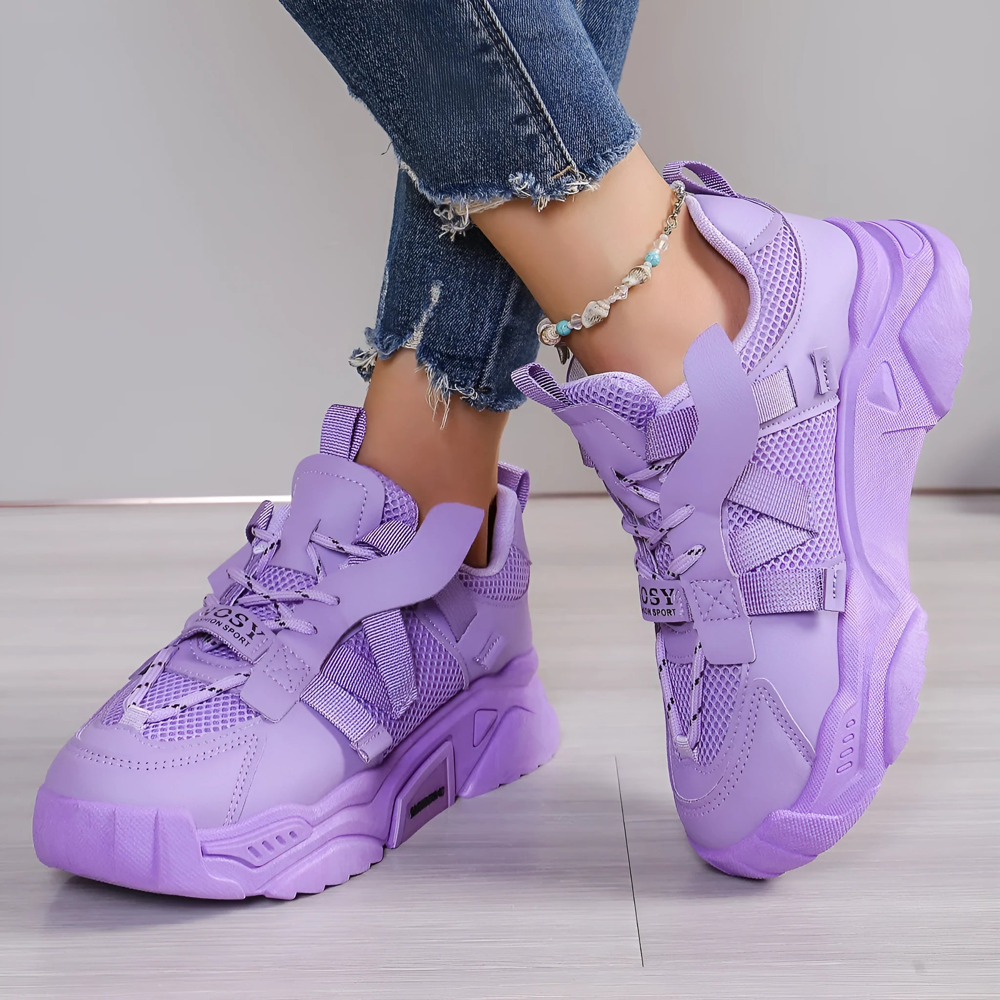 Women's platform sneakers in purple with mesh upper, animal pattern detail, and lace-up front.
