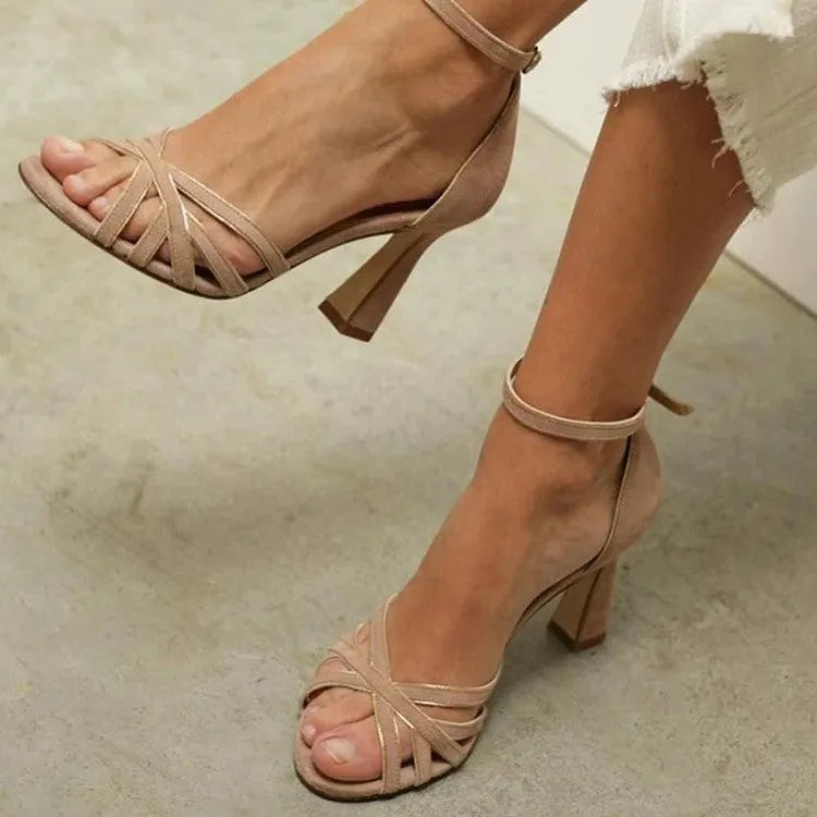 Apricot coloured suede peep toe high heel sandals with a fish mouth toe design on a white background.