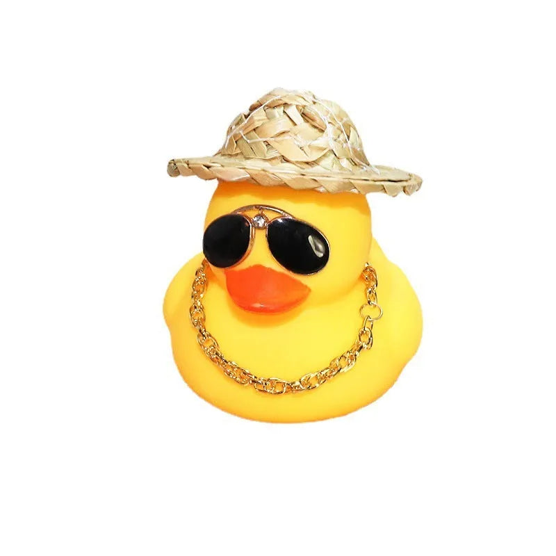 Straw hat yellow duck car dashboard ornament with removable sunglasses necklace on adhesive base.