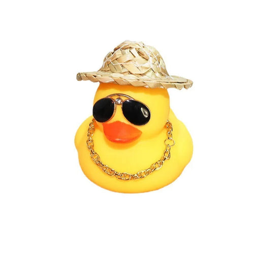 Straw hat yellow duck car dashboard ornament with removable sunglasses necklace on adhesive base.