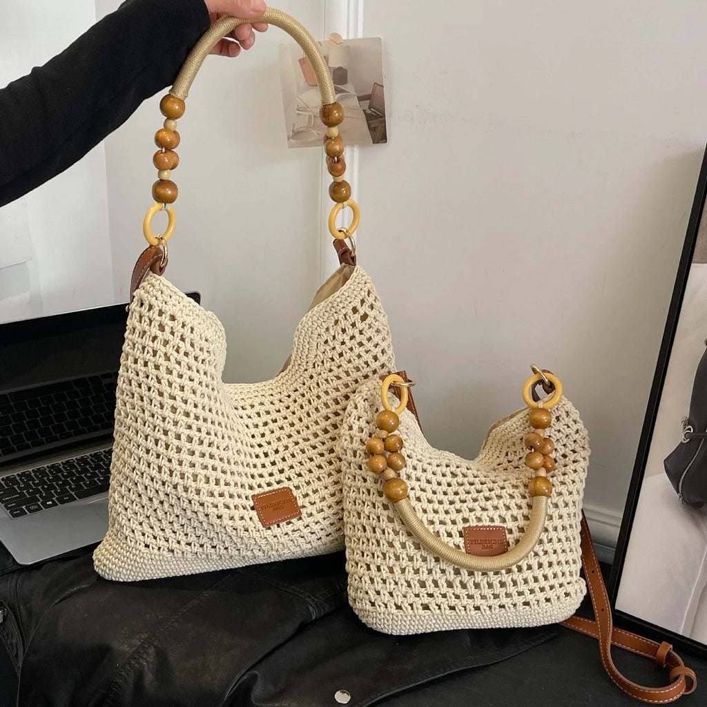 Knitted tote beach bag in bucket shape with crossbody strap showing contrast stitching details