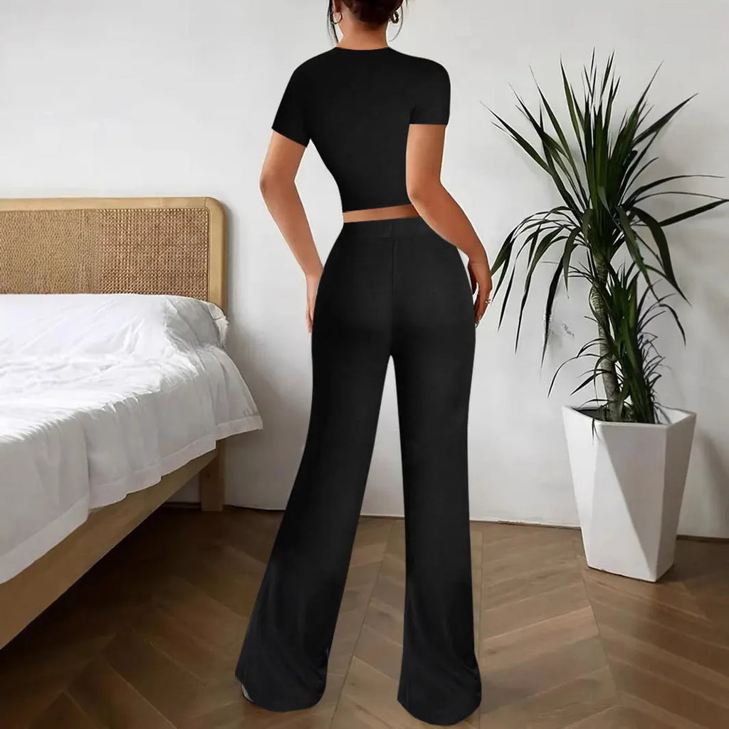 Black high waist trousers and short sleeve t-shirt matching set laid flat showing coordinated outfit