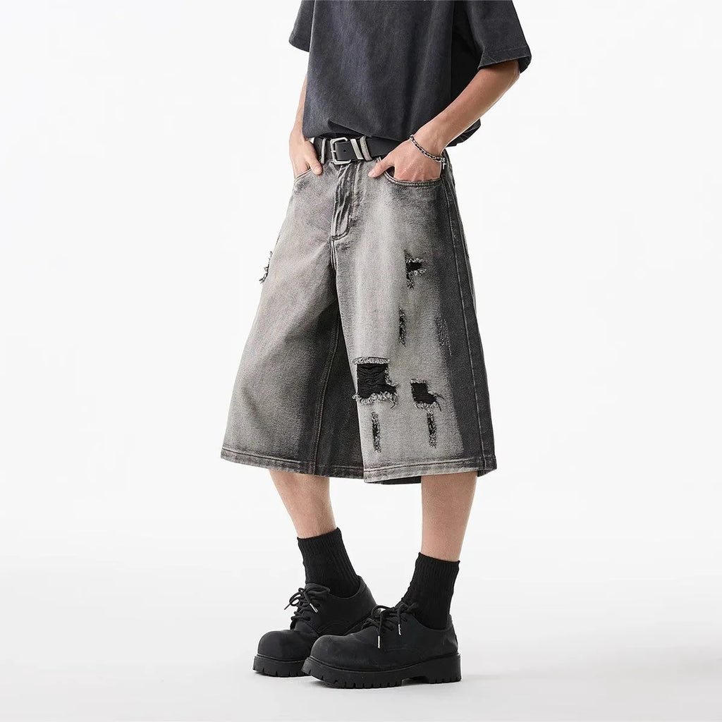 Grey water washed denim shorts with hole detailing and loose cropped fit