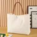 Beige White or White canvas tote bag with durable handles and a spacious main compartment