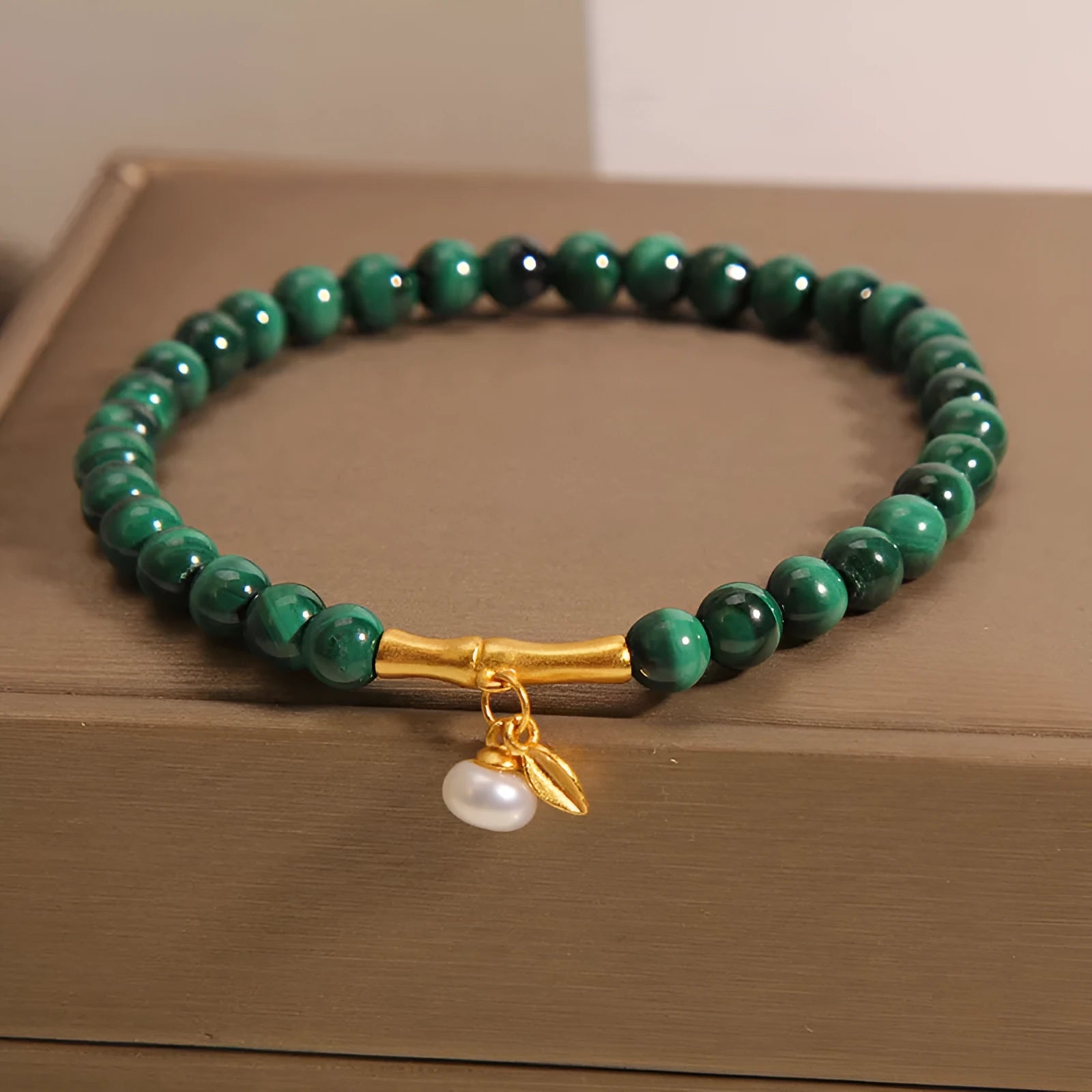 Close-up of a women's white crystal bracelet with a raised lucky bamboo design on the wrist.