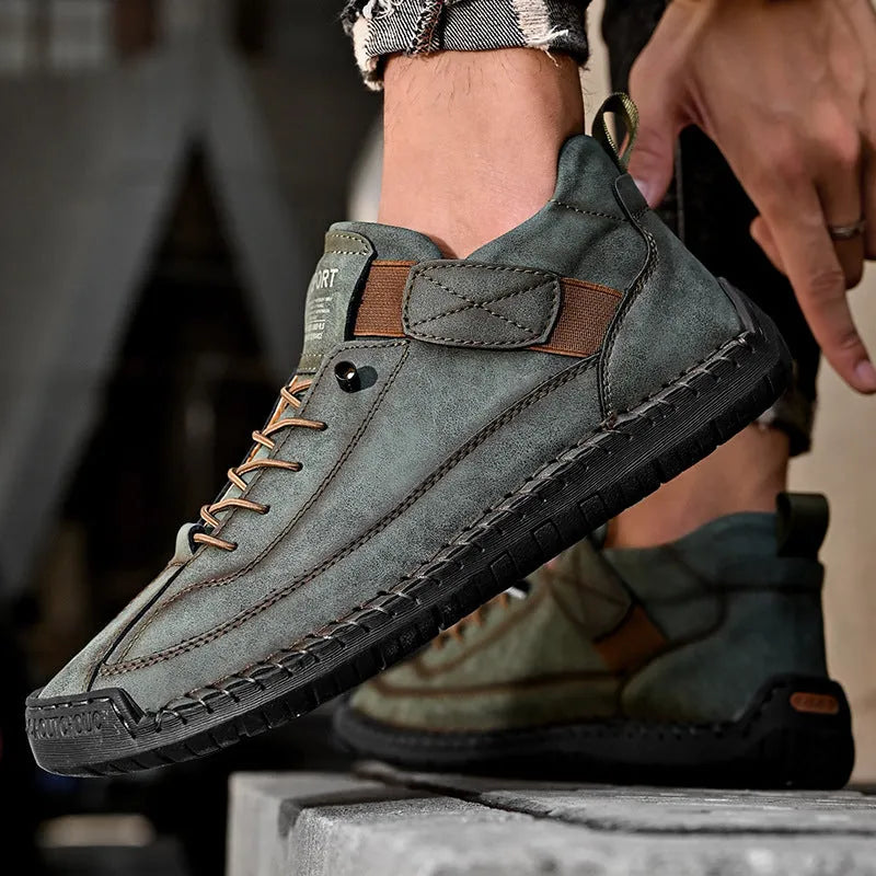 Men's mid-calf black Martin boots with tooling stitching and a flat rubber sole on a white background.